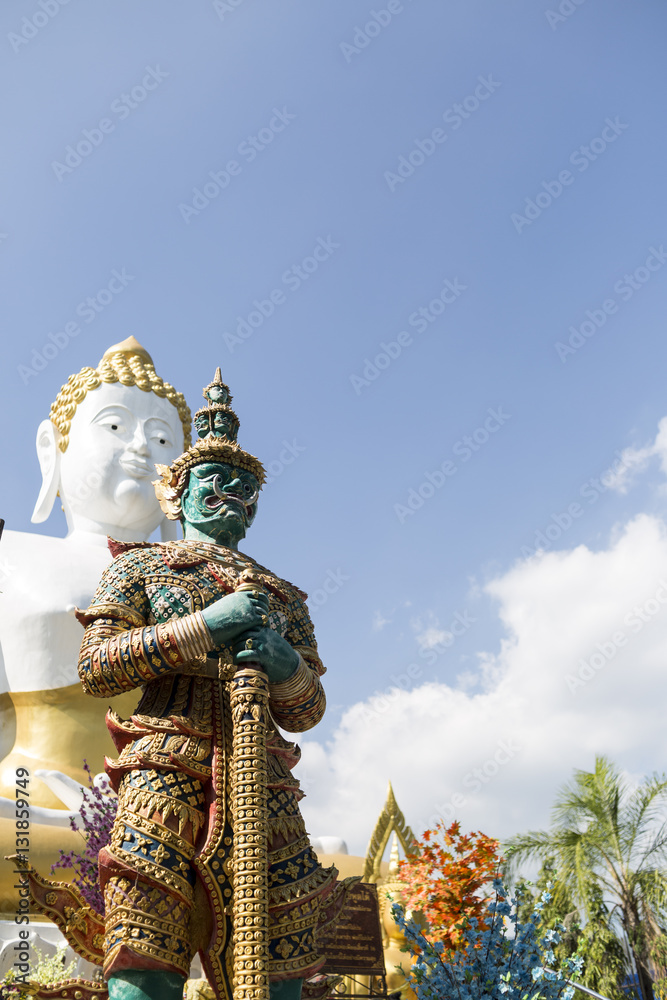 Beautiful giant statue in front of a large Buddha statues in the