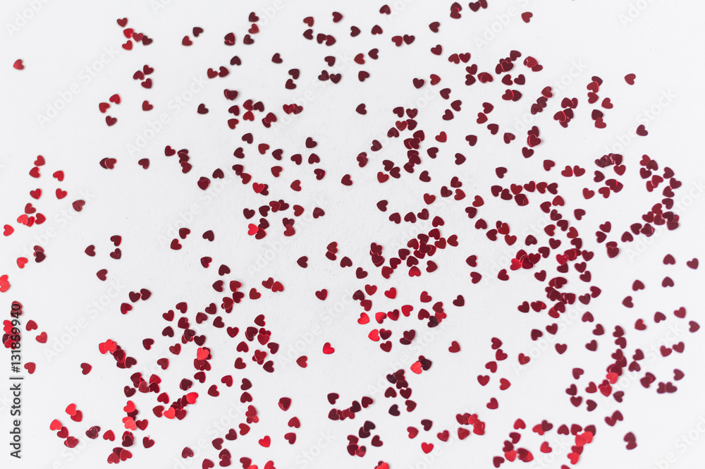a scattering of red hearts on a white background. Texture for Valentine's day a scattering of red hearts on a white background. Texture for Valentine's day