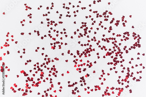 a scattering of red hearts on a white background. Texture for Valentine s day