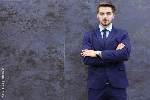 Young businessman on gray t...