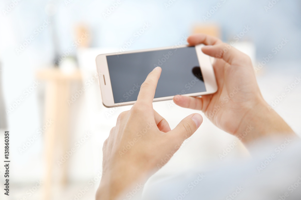 Man using smart phone on blurred background