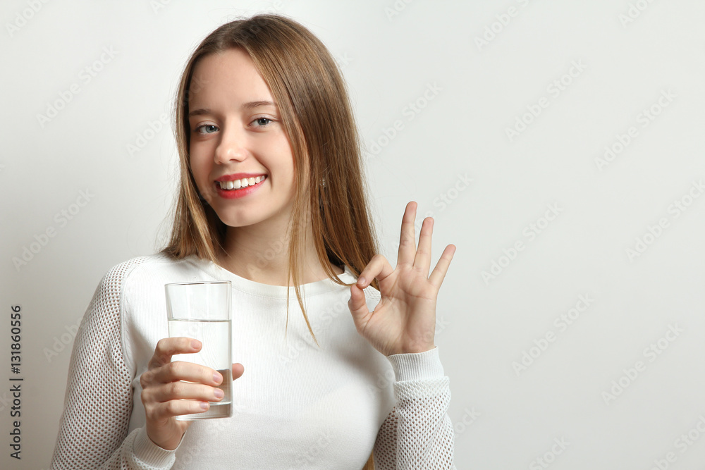 Beautiful smiling girl holding a glass of clean water. Beautiful smiling girl holding a glass of clean water.