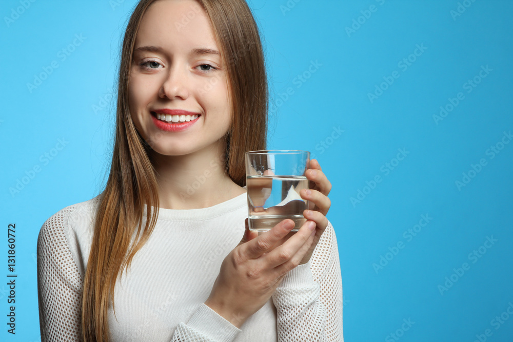 Beautiful smiling girl holding a glass of clean water. Beautiful smiling girl holding a glass of clean water.