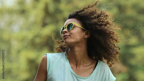 Good-looking multiracial female enjoying music at festival, making dance moves photo