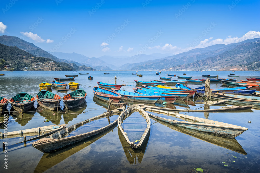 Colorful boats on Phewa lake, Pokhara, Nepal. Wide angle landscape