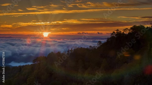 Tilting Up to the Sunrise over the Cloud Covered Smoky Mountains with Sun Rays and Lens Flares following the Camera Movement