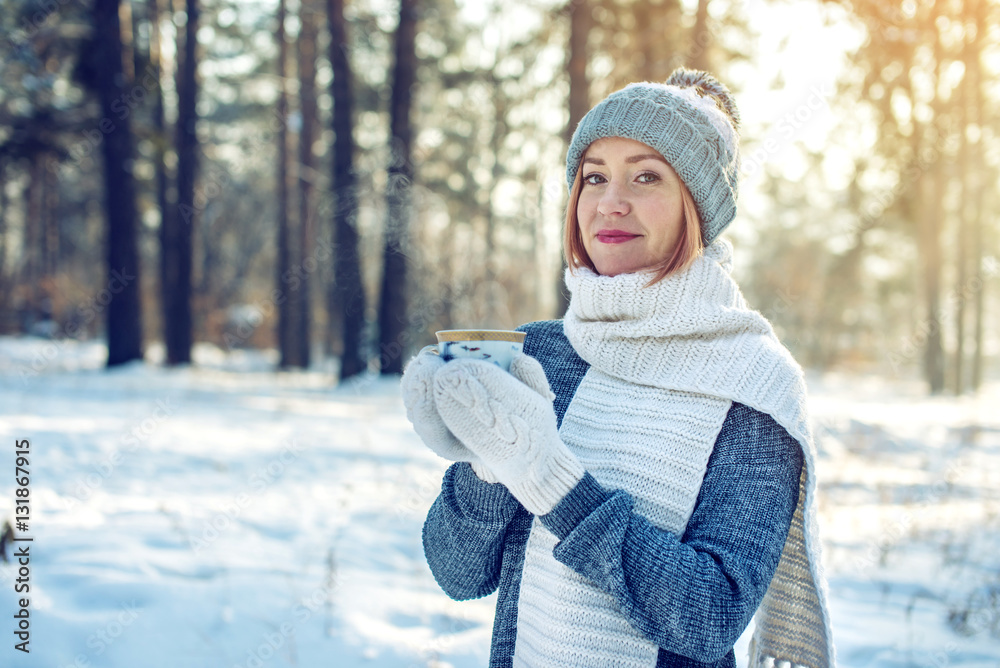 attractive woman in winter drinking hot tea on sunlight attractive woman in winter drinking hot tea on sunlight