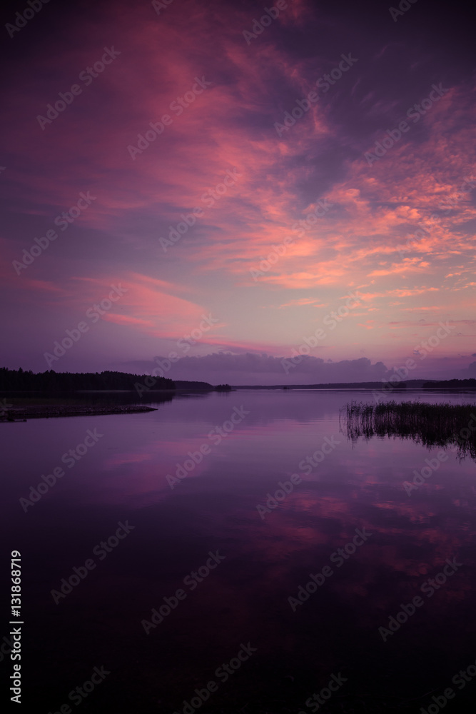 A beautiful, colorful summer sunset over the lake in Finland