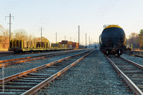 Railroad in autumn going to the city with colorful trees in colors by the tracks in the fall