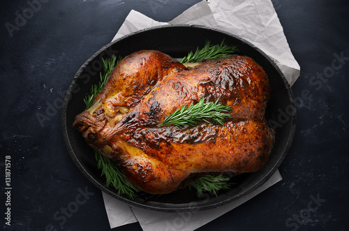 Roasted Thanksgiving Day Turkey in black pot on table photo
