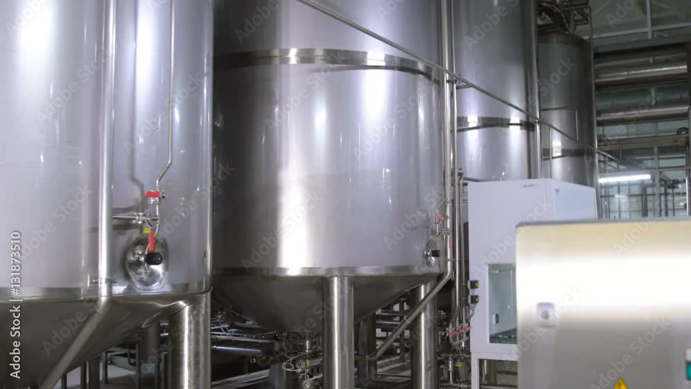 Modern complex technological industrial equipment at a brewery. Steadycam shot. 4K.