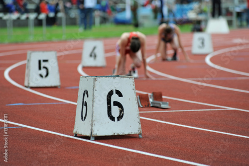 Läuferinnen in Startposition auf Tartanbahn