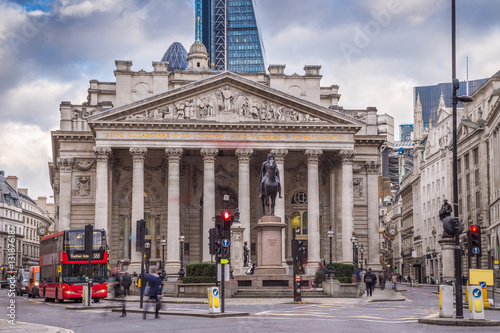 London, England - Iconic red double decker bus and the Royal Exchange building photo