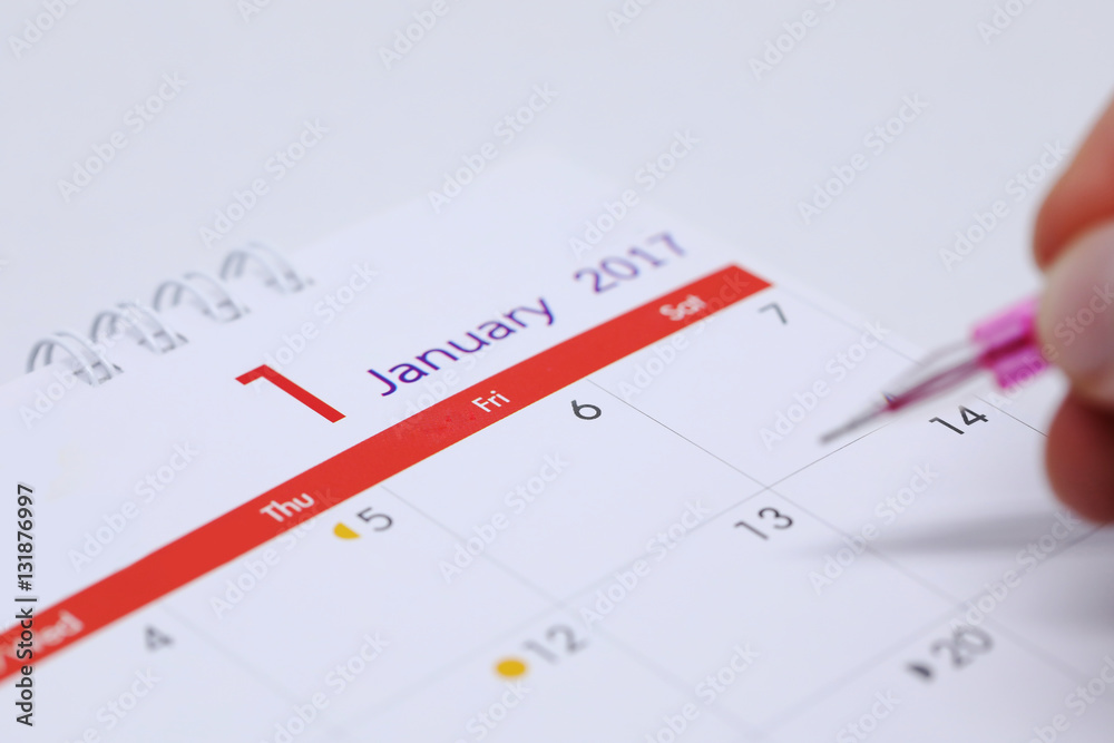 hand writing work schedule on desktop calendar of 1 january 2017 hand writing work schedule on desktop calendar of 1 january 2017