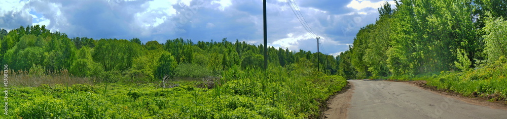 Panoramic landscape with forest, clouds and road Panoramic landscape with forest, clouds and road