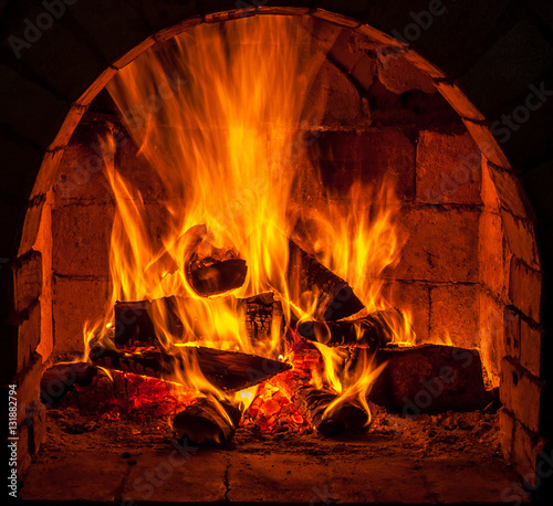 A fire burns in a fireplace