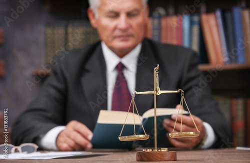 Scales of justice on wooden...