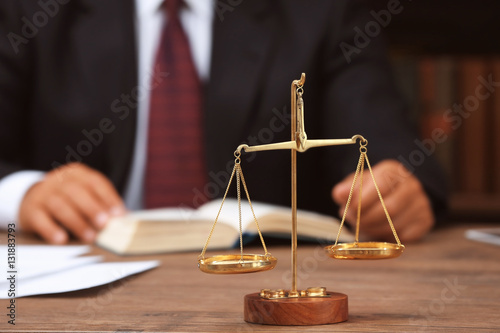 Scales of justice on wooden...