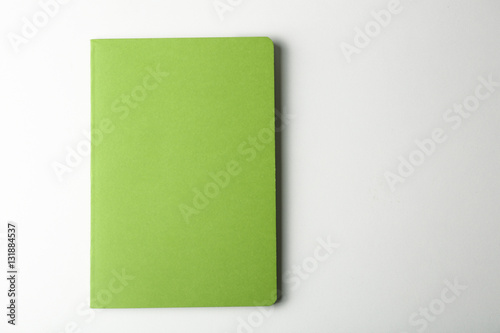 Blank green notebook on white background