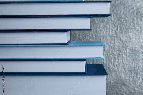 Tableau sur toile Stack of books on gray background, close up