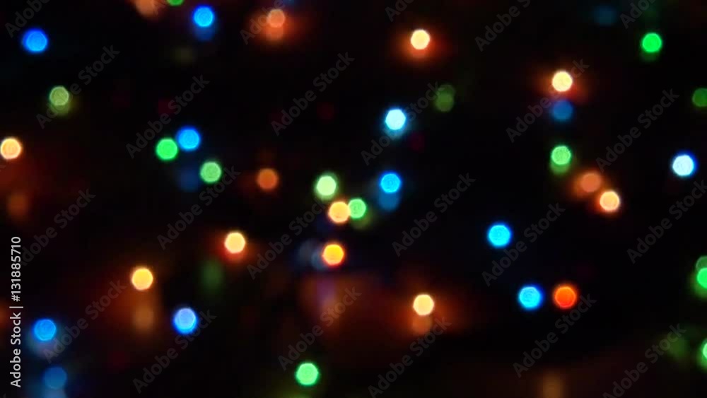 Blurry abstract colorful background. Colored Christmas garland. Bokeh and defocusing of the lens