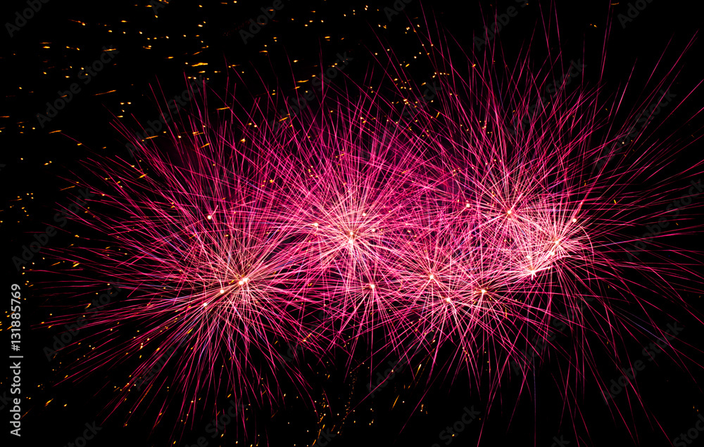Pink fireworks on black background at international competition