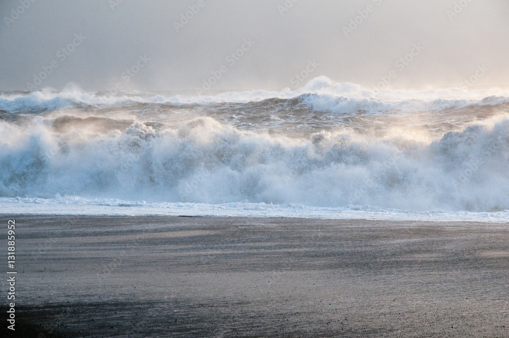 Waves crashing on black sand beach, Iceland