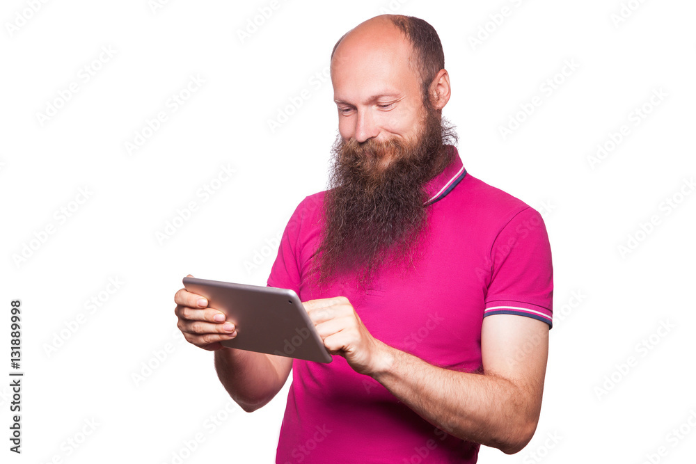 portrait of bald bearded man with tablet and pink t-shirt isolated on white background.
portrait of bald bearded man with tablet and pink t-shirt isolated on white background.