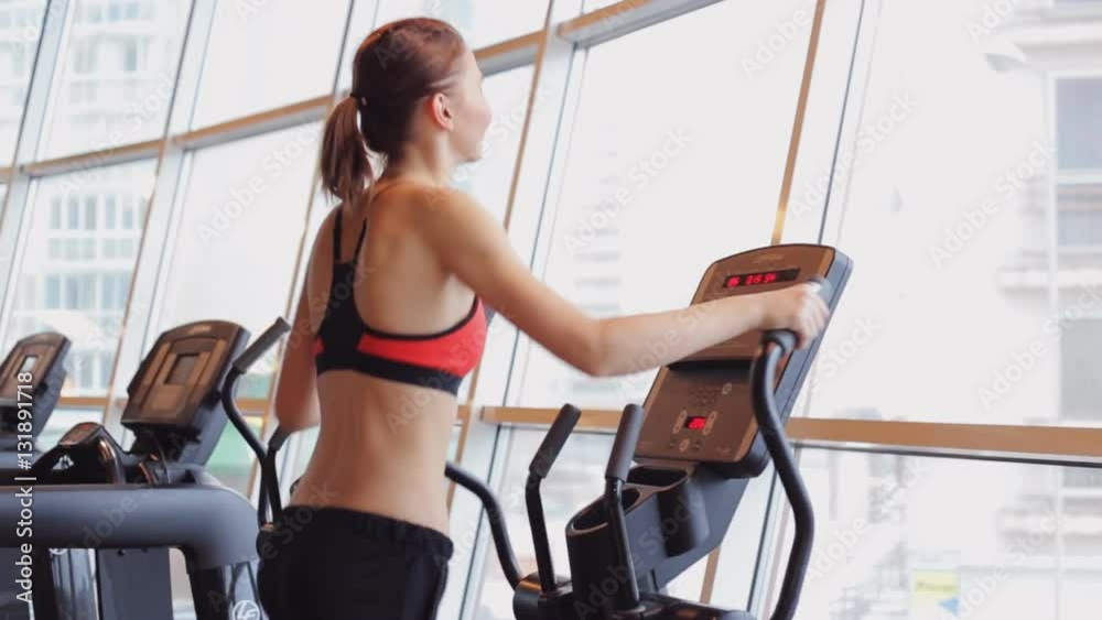 Sports girl doing exercises on the simulator ellipsoid. Sports girl doing exercises on the simulator ellipsoid.