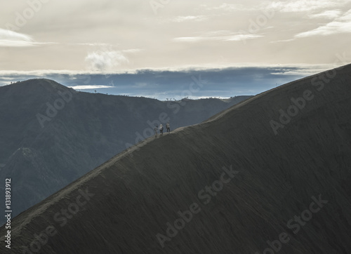 People on top of mountain in hazy landscape