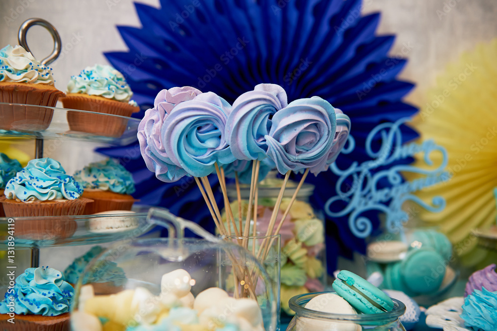 Sweet table for children's birthday party in turquoise and purple. A sense of celebration, of joy. Beautiful sweets Sweet table for children's birthday party in turquoise and purple. A sense of celebration, of joy. Beautiful sweets