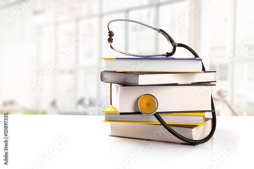 medical education - stack of books with stethoscope on the table