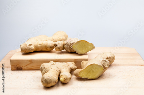 Ginger pieces on wooden kitchen board
