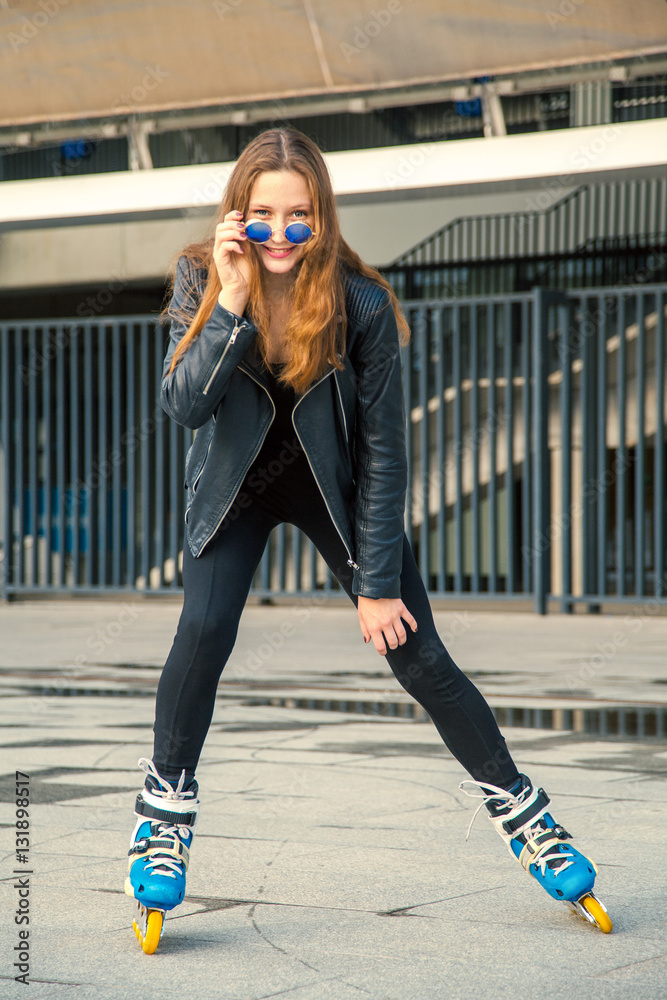 Girl on rollerblades standing in building background. Young fit women girl  in blue sunglasses, jeans and jacket on roller skates riding outdoors after  rain. Photos | Adobe Stock