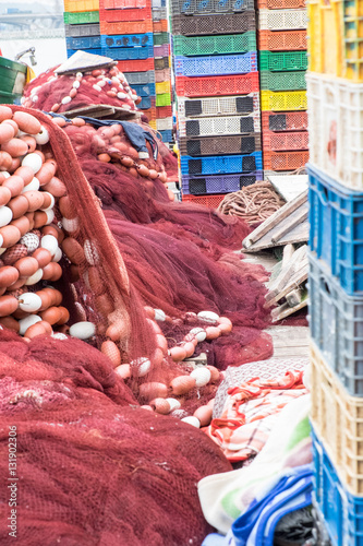 Africa,North Africa,Morocco, Rabat,Sale,red and white fishing nets stacked next to colorful plastic crates on dock, near mouth of the Bou Regreg river. photo