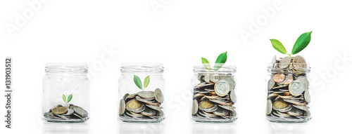 Money saving growth concepts, glass jar with coins and plants growing, isolated on white background