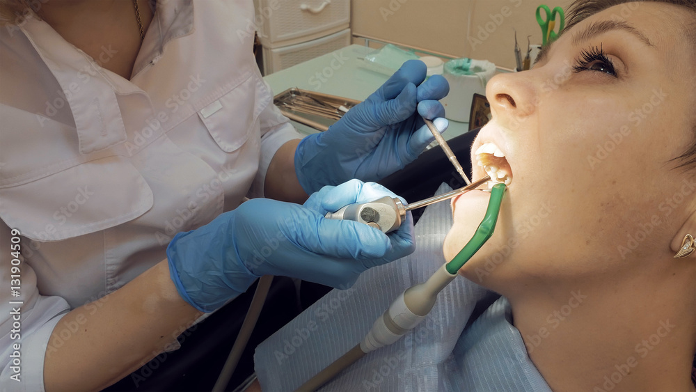 Woman at the dentist clinic office gets dental medical examination and treatment. Odontic and mouth health is important part of modern human life that dentistry help with. Woman at the dentist clinic office gets dental medical examination and treatment. Odontic and mouth health is important part of modern human life that dentistry help with.
