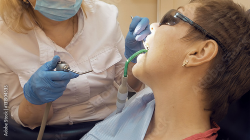 Woman at the dentist clinic office gets dental medical examination and treatment. Odontic and mouth health is important part of modern human life that dentistry help with.