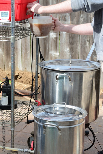 Two home brew kettles boiling wort with propane tank