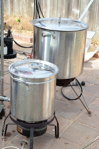 Two home brew kettles boiling wort with propane tank