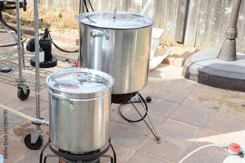 Two home brew kettles boiling wort with propane tank