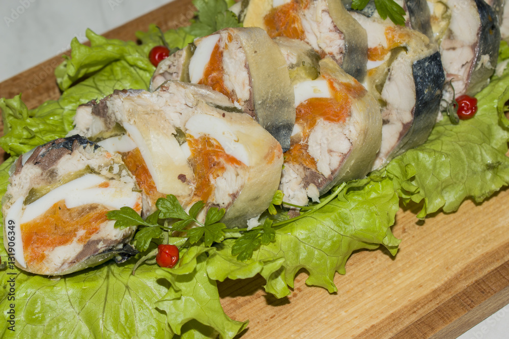 Roll of mackerel with vegetables on a wooden Board Roll of mackerel with vegetables on a wooden Board