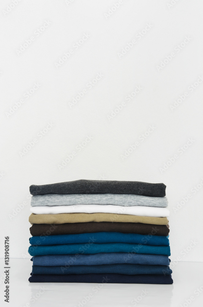 stack of t-shirt on white background, copy space stack of t-shirt on white background, copy space