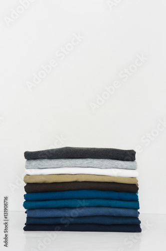 stack of t-shirt on white background, copy space