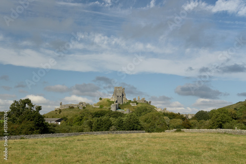 View over fields to Corfe Castle above graveyard, Dorset