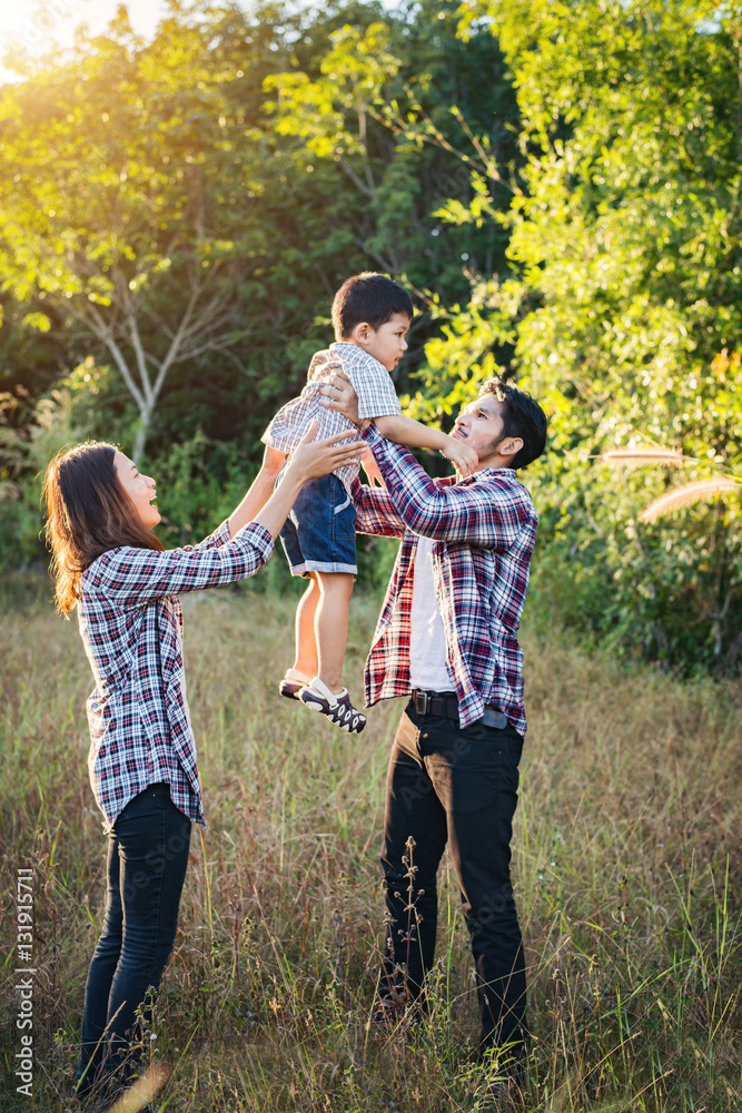 Fototapeta premium Happy young family spending time together outside in green natur