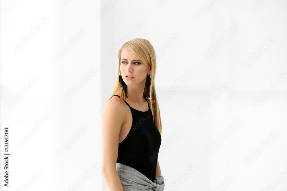Pretty young blonde woman against light background Pretty young blonde woman against light background