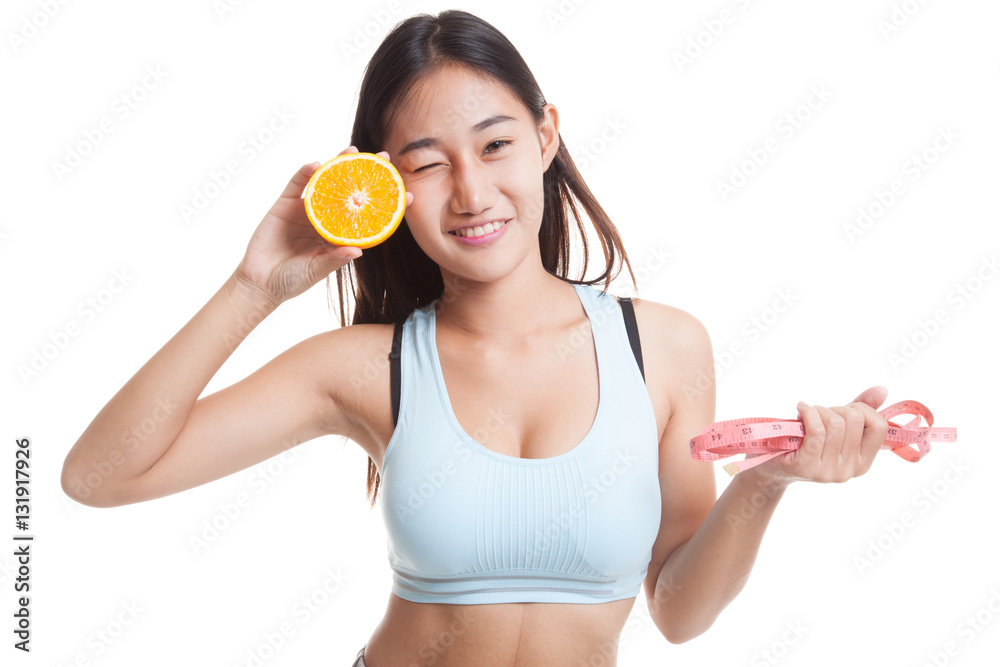 Asian healthy girl on diet with orange fruit and measuring tape. Asian healthy girl on diet with orange fruit and measuring tape.