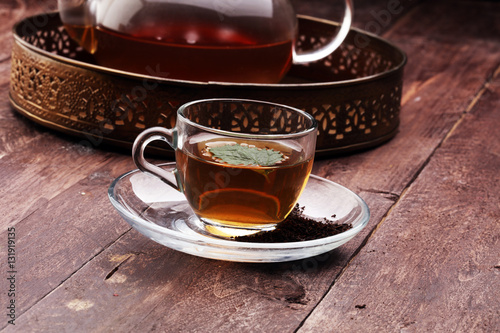 Tea. Herbal tea. Mint leaf. Tea in a glass cup  mint leaves  dried tea  sliced lime. herbs and mint leaves on a slate plate in a restaurant or teahouse tea room.