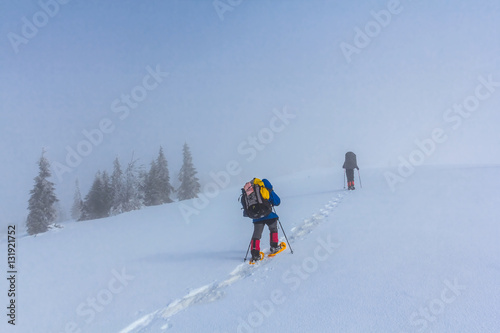 touristic group walking through a winter hills